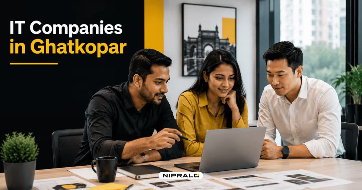 Business owner comparing IT companies in Ghatkopar on a laptop while a diverse Mumbai team reviews website and software project options in 2026